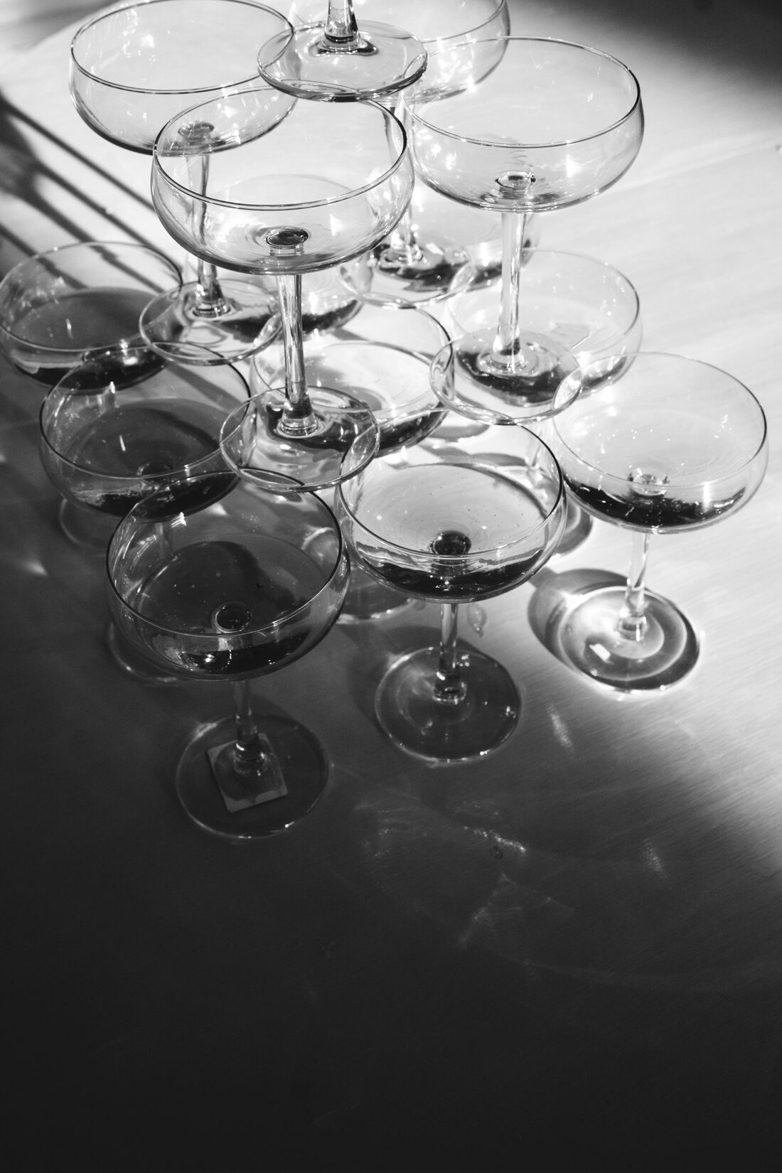 An elegant tower of stacked coupe champagne glasses